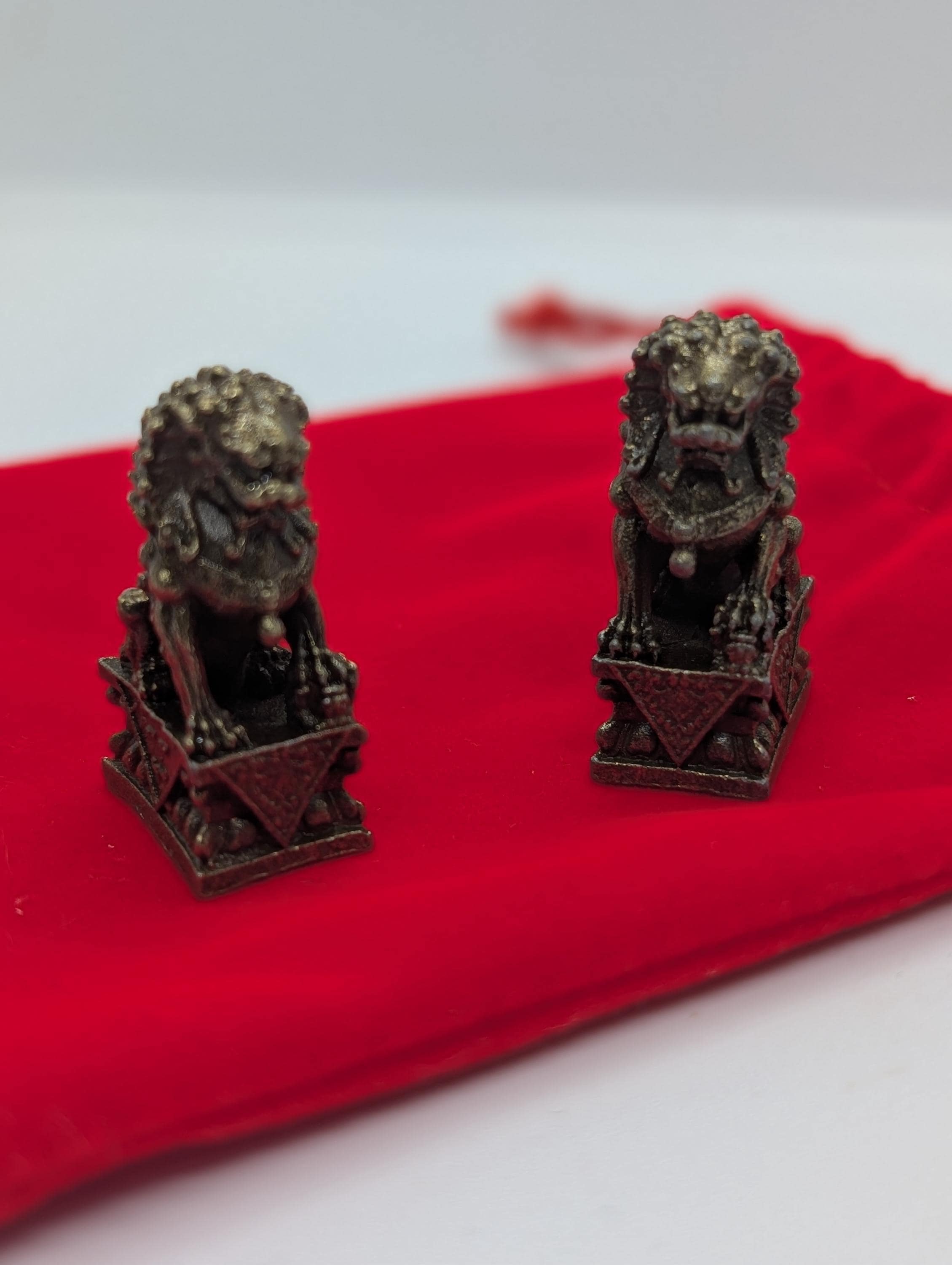 Brass foo dog, lucky lion miniature,  cca 0.98 in  x 1.38 in, pair of two similar in red velvet sachet