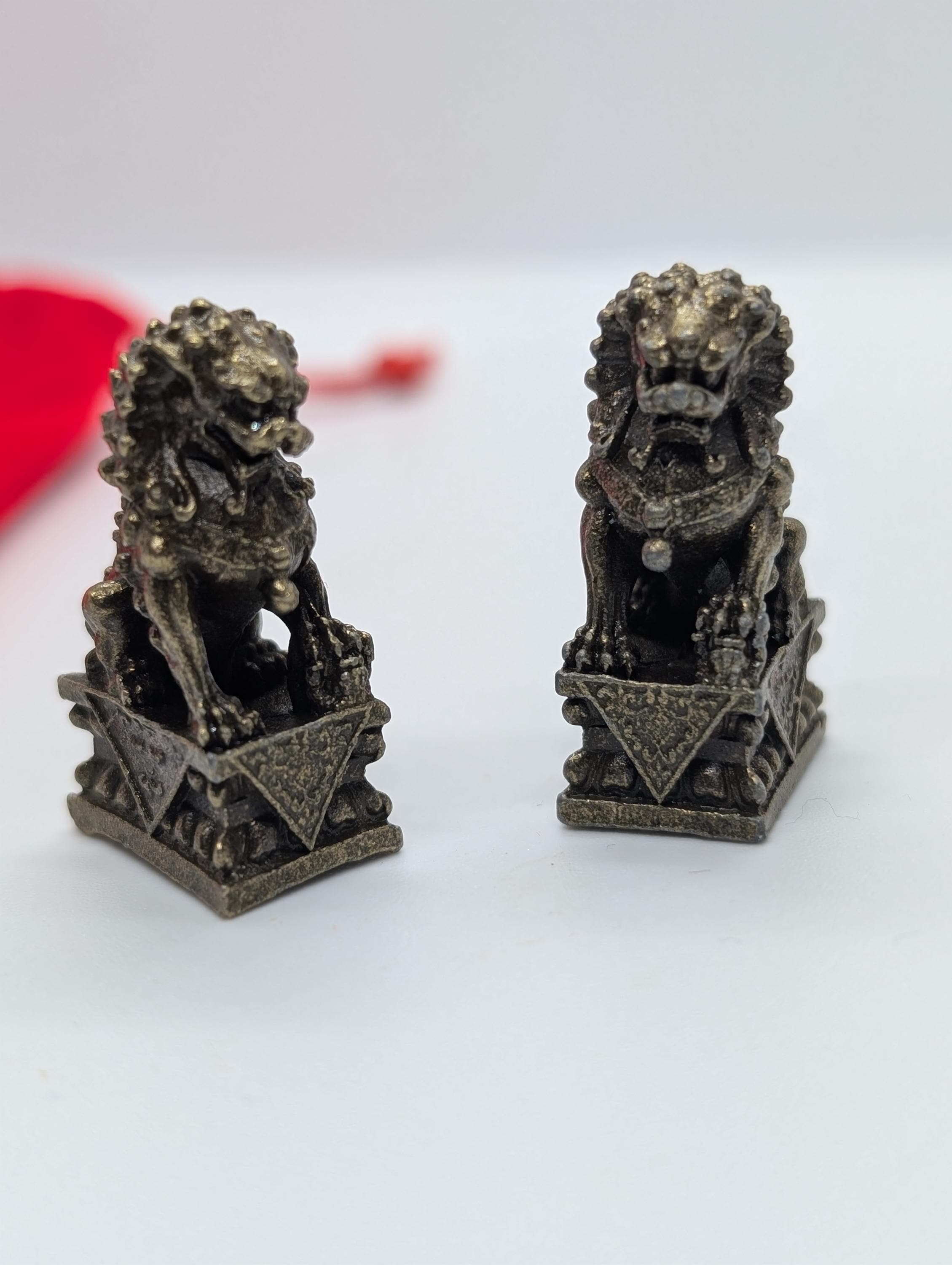 Brass foo dog, lucky lion miniature,  cca 0.98 in  x 1.38 in, pair of two similar in red velvet sachet